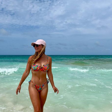 Woman posing in a bikini standing in Great Guana Cay's water 