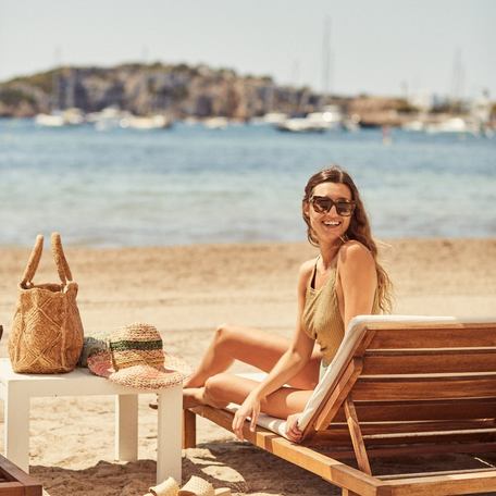 Woman sunbathing on one of Ibiza Bays sunloungers