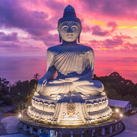 Overview of The Big Buddha landmark in Phuket, with a pink sky in the background.