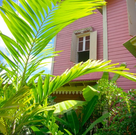Pink house with opened shutters