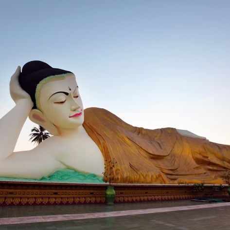 Reclining Buddha covered with a blanket statue