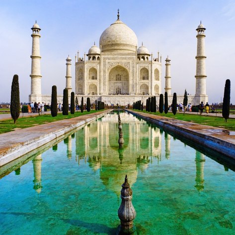 Taj-Mahal mausoleum with big garden visiting by tourists 