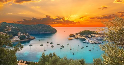 Ibiza harbor with anchored yachts at sunset