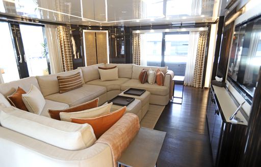 Main salon onboard charter yacht ANDIAMO with plush cream seating