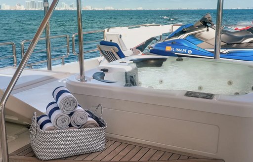 Jacuzzi with towels in foreground on motor yacht ENTREPRENEUR