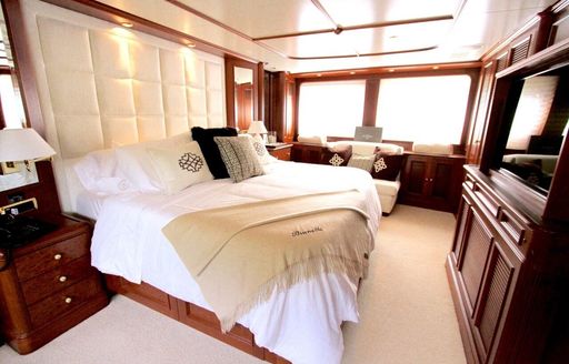 master suite with neutral coloured furnishings and rich wood joinery on board superyacht BRUNELLO