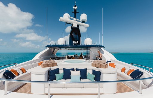 Overview of the sun deck onboard charter yacht STARBURST IV, with a central deck Jacuzzi and surrounding seating