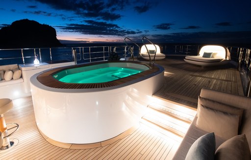 spa pool on sun deck at night of superyacht driftwood