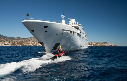 Charter guest riding Jet-Skis around superyacht Lauren L