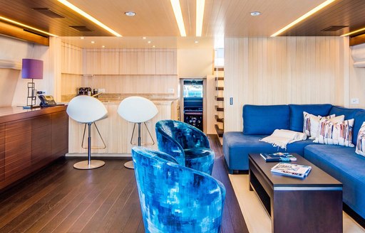 Luxury yacht LULA seating area, with bar stools and blue sofas