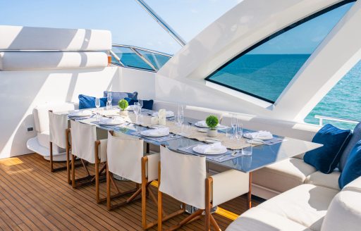 Alfresco dining table and directors chairs onboard charter yacht CARPE DIEM