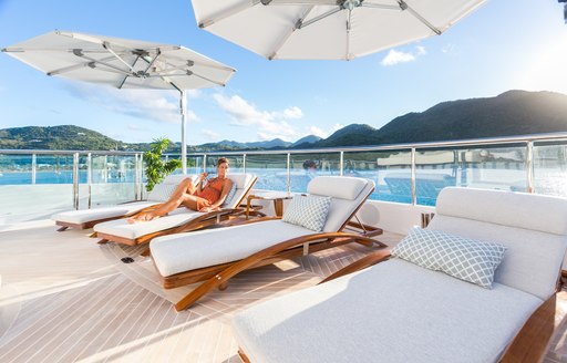 Woman lying on one of the sun deck day beds 