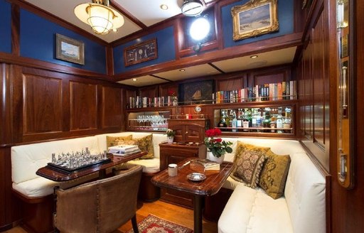 Lower salon with seating area and mahogany panel on board luxury yacht silver spray