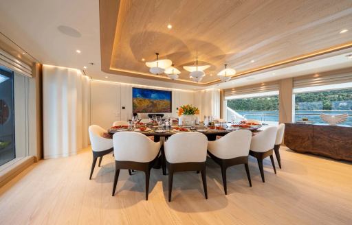 Superyacht charter QU2 interior dining table and large windows