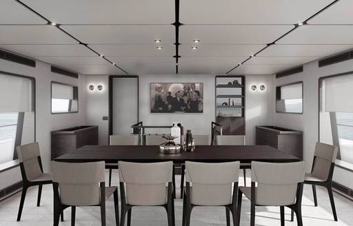 Dining area with long table and chairs onboard charter yacht TWINS
