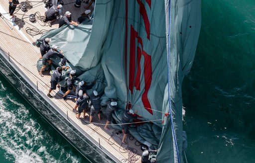 sailors on deck of superyacht during nz millenium cup