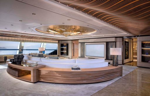 Indoor cinema area onboard charter yacht MALIA with large screen and adjacent sofas