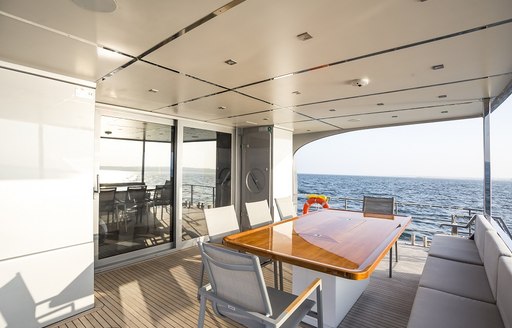 shaded al fresco dining area on board motor yacht Timeless 