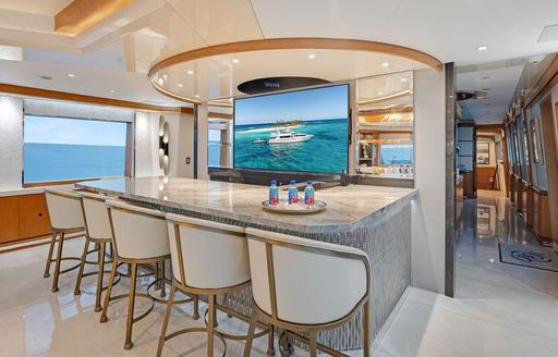 Charter yacht XOXO wet bar with cream stools