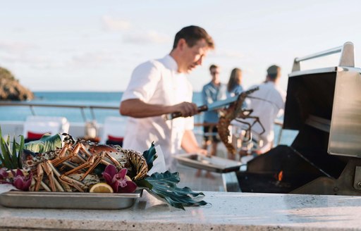 Yacht chef prepares BBQ onboard MY Flag