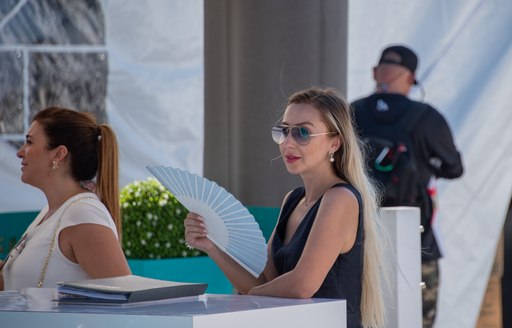 Woman sits on stand at FLIBS 2019