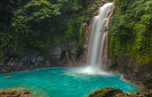 Beautiful waterfall with jade waters in Costa Rica