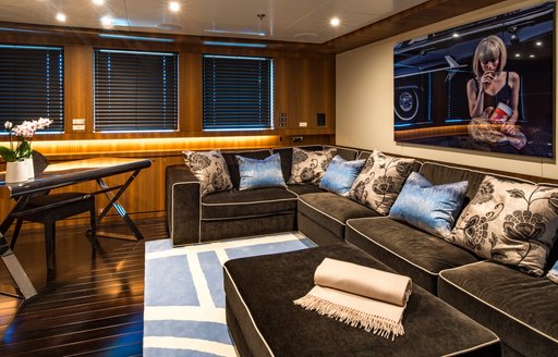 Comfortable seating area on art work in lounge of superyacht RARITY