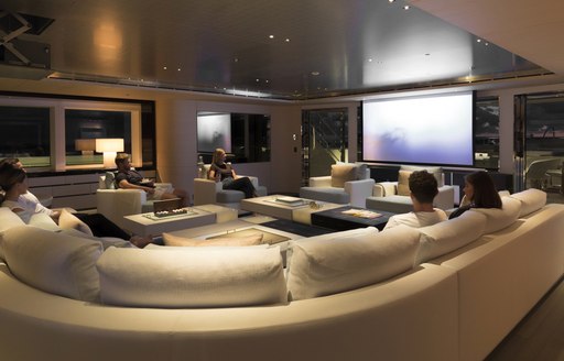 guests watch a movie in the games room aboard motor yacht NAUTILUS 