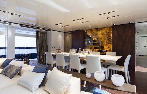 white lacquer dining table in the main salon of motor yacht Lucky Me 