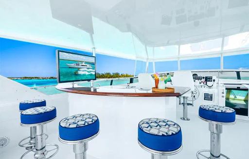 Charter yacht ESCAPE wet bar and blue stools