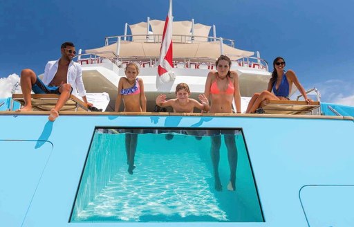 A family enjoys the swimming pool onboard MY Axioma