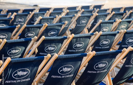 Rows of deckchairs on the beach in Cannes with Festival de Cannes printing