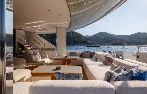 Aft deck with cream sofas onboard charter yacht LADY A