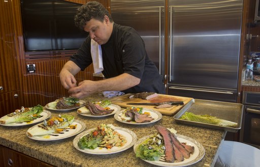 chef Ian Gabbe of motor yacht Renaissance prepares his winning dish at the Newport Charter Show 2017