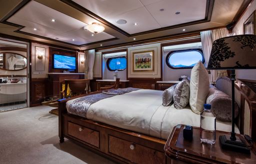 Charter yacht AQUA LARES guest cabin with central berth and porthole windows