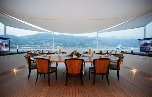 Exterior dining table onboard charter yacht PLAN B