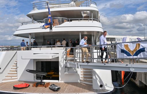 A superyacht charter berthed at the Croatia Yacht Show with many visitors exploring