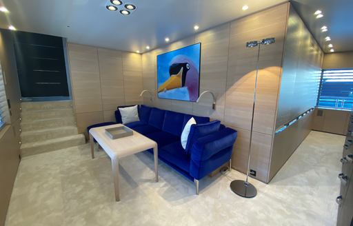 Charter yacht BOLD master cabin seating area with blue sofa