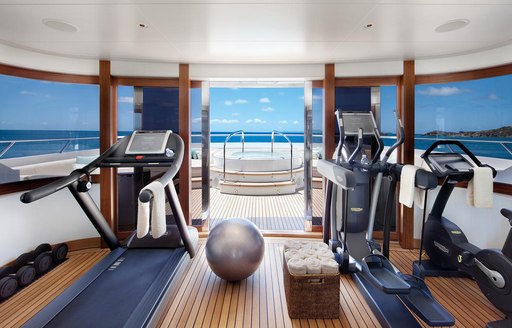 Two treadmills on opposite sides of a superyacht gymnasium