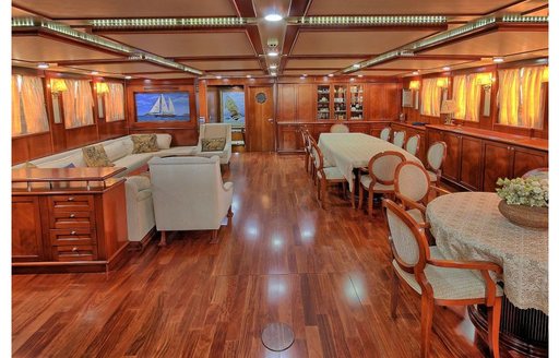 Lounge and dining areas in main salon of charter yacht Sea Dream