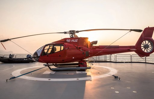 red helicopter onboard luxury expedition yacht charter OCTOPUS