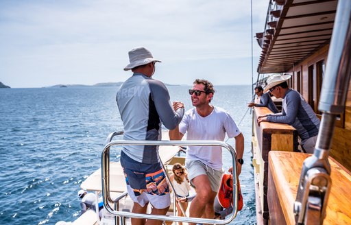 LAMIMA yacht being boarded by charter guests 