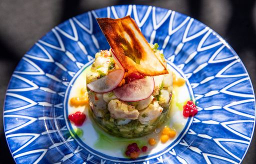 Plated premium superyacht cuisine on blue dish