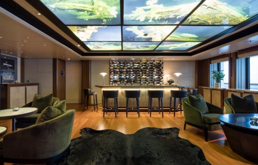 Interior seating area with wet bar onboard superyacht charter OCTOPUS