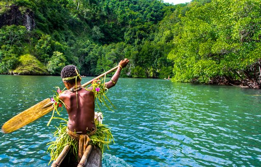 man in boat in papua new guinea 