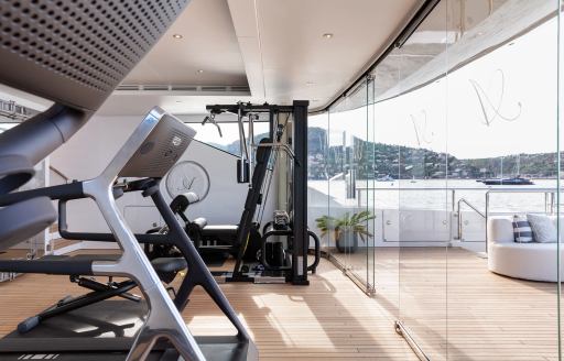 Overview of a gym with full height glazing onboard charter yacht LADY A