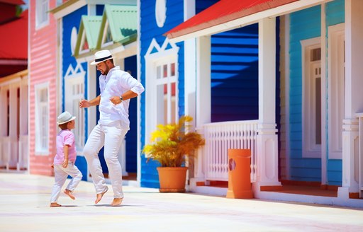 happy father and son enjoy life, dancing on caribbean street