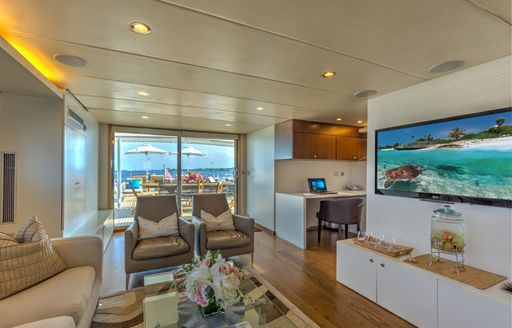 Skylounge seating area and large TV screen on board charter yacht LIONSHARE