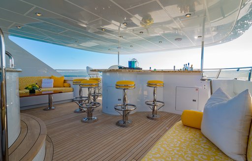 Charter yacht I LOVE THIS BOAT exterior wet bar and yellow stools