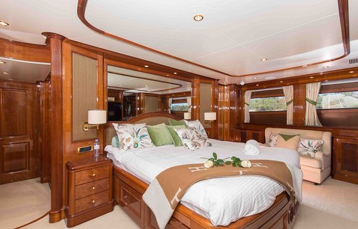 master suite with large bed at its centre aboard motor yacht DXB 